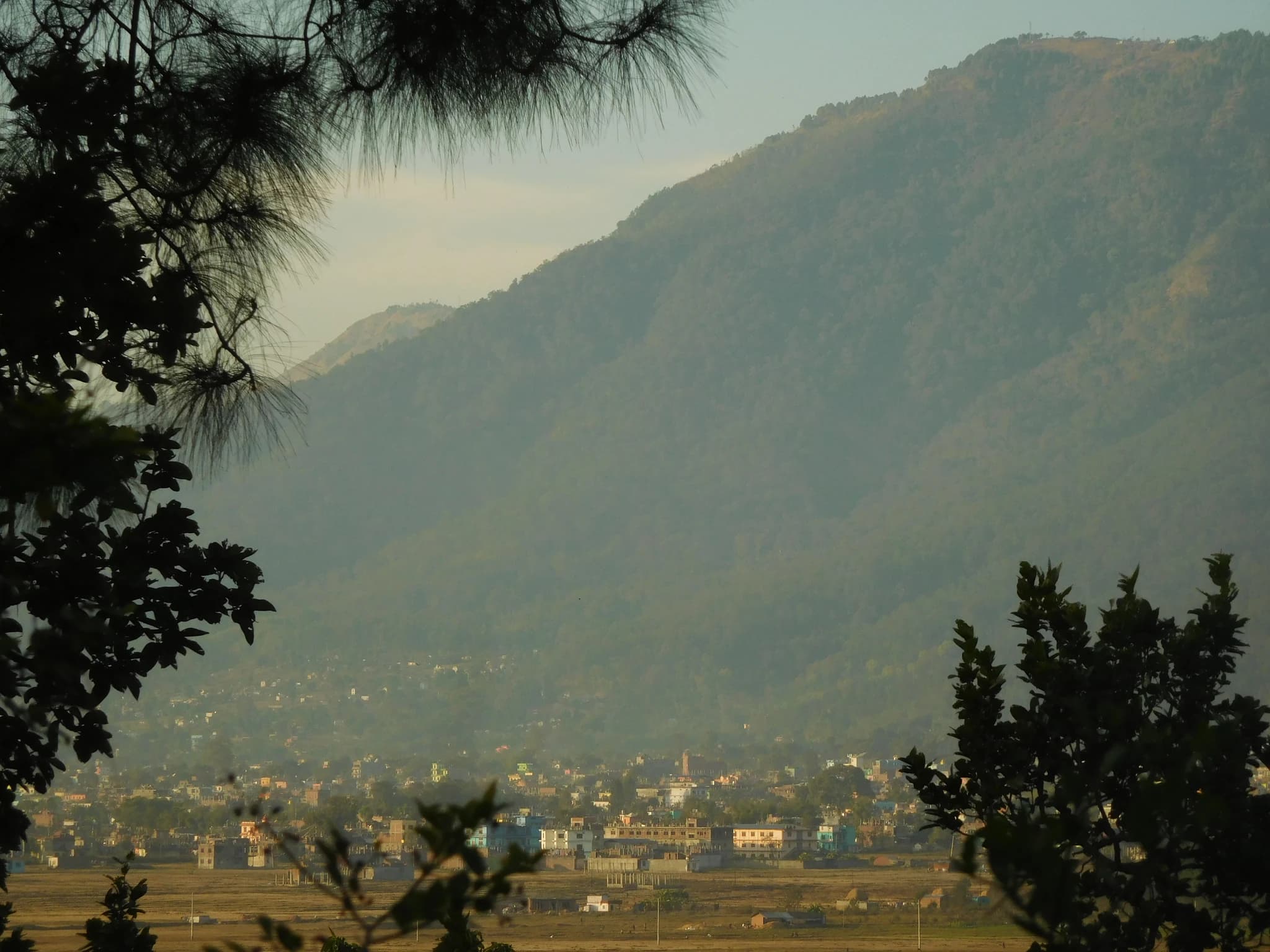 Panoramic view of the green Surkhet Valley basin seen through the sal forests of Kakre Bihar reserve