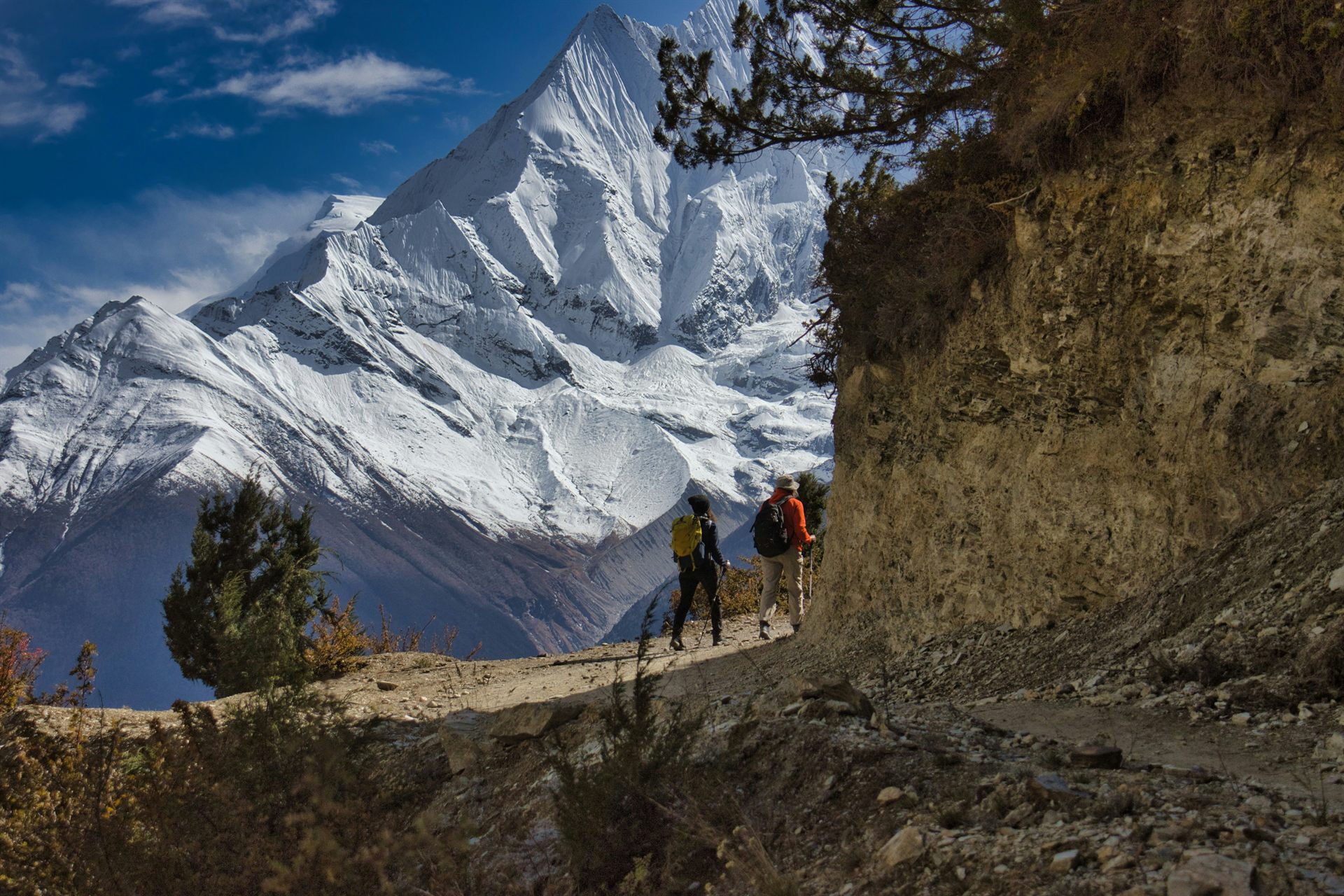 Trekkers moving through the Annapurna region of Nepal with Himalayan mountains nearby